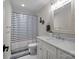 Nautical themed bathroom with a white vanity, white marble countertops, and a shower with a blue and white striped curtain at 463 Lake Wylie Rd, Belmont, NC 28012