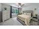 Relaxing bedroom featuring a large window, gray accents, and soft carpeting at 463 Lake Wylie Rd, Belmont, NC 28012