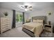 Well-lit bedroom with ceiling fan, comfy bed, natural light, and a gray upholstered headboard at 463 Lake Wylie Rd, Belmont, NC 28012