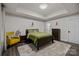 Tranquil bedroom with a plush rug, tray ceilings, and ample closet space at 463 Lake Wylie Rd, Belmont, NC 28012