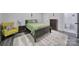 Cozy bedroom with green bedding, a fluffy rug, and stylish yellow chair at 463 Lake Wylie Rd, Belmont, NC 28012