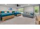 Bedroom featuring two wood-framed beds, a sofa, and a ceiling fan, perfect for relaxation and comfort at 463 Lake Wylie Rd, Belmont, NC 28012