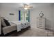 Cozy bedroom with a ceiling fan, large windows, and a dresser, offering a comfortable retreat at 463 Lake Wylie Rd, Belmont, NC 28012
