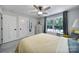 Bright bedroom features a ceiling fan, and a view to the outdoors through a window at 463 Lake Wylie Rd, Belmont, NC 28012