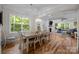 Spacious dining room with hardwood floors, chandelier, and open view to the living room at 463 Lake Wylie Rd, Belmont, NC 28012