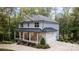 Side view of a two-story home with stone accents, metal roof, attached garage, and landscaped yard at 463 Lake Wylie Rd, Belmont, NC 28012