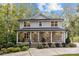 Charming two-story home with stone accents, metal roof, covered front porch, and lush landscaping at 463 Lake Wylie Rd, Belmont, NC 28012