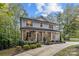 Exterior of the home showcasing the stone facade and a basketball hoop on the driveway at 463 Lake Wylie Rd, Belmont, NC 28012
