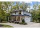 Charming home with a stone facade, inviting front porch, and an attached garage at 463 Lake Wylie Rd, Belmont, NC 28012
