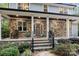 Inviting front porch with stone columns, rocking chairs, and well-maintained landscaping at 463 Lake Wylie Rd, Belmont, NC 28012