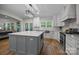 Bright kitchen with an island, hardwood floors, stainless appliances, and access to outdoor living space at 463 Lake Wylie Rd, Belmont, NC 28012