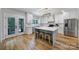Bright kitchen with white cabinets, center island with seating, and stainless steel appliances at 463 Lake Wylie Rd, Belmont, NC 28012