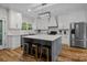 Modern kitchen featuring an island with marble countertops, stainless steel appliances, and hardwood floors at 463 Lake Wylie Rd, Belmont, NC 28012