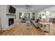Bright living room featuring a fireplace, hardwood floors, and large windows with wooded views at 463 Lake Wylie Rd, Belmont, NC 28012