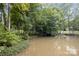 A serene water view showcases the lush greenery surrounding this beautiful lakeside property at 463 Lake Wylie Rd, Belmont, NC 28012
