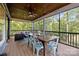 Inviting screened porch with a dining table, cozy seating, and scenic views at 463 Lake Wylie Rd, Belmont, NC 28012