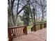 A view of the wooden deck with railings and trees surrounding the deck at 4805 Horizon Cir, Charlotte, NC 28215