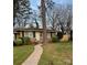 Inviting single-story brick home with well-maintained lawn, landscaping, and classic design elements at 4805 Horizon Cir, Charlotte, NC 28215