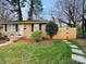Charming brick home with a manicured lawn, landscaping and a welcoming entryway with steps at 4805 Horizon Cir, Charlotte, NC 28215