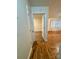 Hallway with hardwood floors leading into rooms with natural light at 4805 Horizon Cir, Charlotte, NC 28215