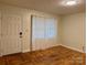 Living room featuring a front door, hardwood floors, and a window with curtains at 4805 Horizon Cir, Charlotte, NC 28215