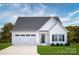 Charming single-story home featuring a white exterior, well-manicured lawn, and an attached two-car garage at 510 Kenyon Dr, Denver, NC 28037