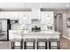 Modern kitchen featuring white cabinets, stainless steel appliances, granite countertops, and a spacious island with seating at 510 Kenyon Dr, Denver, NC 28037