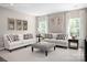 Inviting living room with neutral tones, comfortable seating, stylish decor, and natural light from large windows at 510 Kenyon Dr, Denver, NC 28037