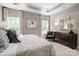 Comfortable main bedroom with large windows, neutral tones, a plush bed, and elegant furnishings at 510 Kenyon Dr, Denver, NC 28037