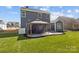 Landscaped backyard featuring a covered patio with stylish gray siding on a sunny day at 5813 Mcclintock Dr, Denver, NC 28037
