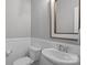 A clean, well-maintained bathroom with white fixtures and wainscoting at 5813 Mcclintock Dr, Denver, NC 28037