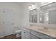 Bright bathroom featuring a double vanity with marble countertop and modern fixtures at 5813 Mcclintock Dr, Denver, NC 28037