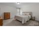 Bedroom with natural light; features a comfortable bed, dresser, and side table at 5813 Mcclintock Dr, Denver, NC 28037