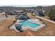 Aerial view of the community pool area featuring a large pool, slides, and seating areas at 5813 Mcclintock Dr, Denver, NC 28037