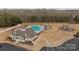 Community pool area with playground, clubhouse, and ample parking space on a sunny day at 5813 Mcclintock Dr, Denver, NC 28037