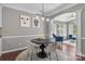 Dining area with modern chandelier and art, flowing into a cozy living space at 5813 Mcclintock Dr, Denver, NC 28037
