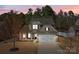 Charming two-story home with stone accents, attached two-car garage, and inviting front porch seating at 5813 Mcclintock Dr, Denver, NC 28037
