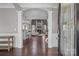 Elegant foyer featuring hardwood floors, classic columns, and an open view into the living spaces at 5813 Mcclintock Dr, Denver, NC 28037