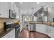 Spacious kitchen featuring stainless steel appliances, breakfast bar, and eat-in dining area at 5813 Mcclintock Dr, Denver, NC 28037