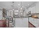 Spacious kitchen featuring a center island with seating and pendant lighting, and white cabinets at 5813 Mcclintock Dr, Denver, NC 28037