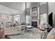 Inviting living room featuring a fireplace, soaring ceilings, and ample seating at 5813 Mcclintock Dr, Denver, NC 28037