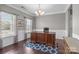 Bright office featuring hardwood floors, a large wooden desk, and natural light from the windows at 5813 Mcclintock Dr, Denver, NC 28037