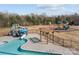 Aerial view of the neighborhood pool, slides and playground in fenced play area with wooden pergola at 5813 Mcclintock Dr, Denver, NC 28037