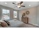 Bright bedroom with two windows, ceiling fan and neutral decor at 6282 Tea Olive Dr # Lot 236, Harrisburg, NC 28075