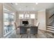 Bright dining area with modern chandelier and sliding glass doors to outdoor seating at 6282 Tea Olive Dr # Lot 236, Harrisburg, NC 28075