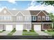 New construction townhome with brick facade, single car garage, and manicured lawn at 6282 Tea Olive Dr # Lot 236, Harrisburg, NC 28075