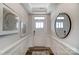 Inviting hallway with decorative trim, mirror, and a front door with sidelights at 6282 Tea Olive Dr # Lot 236, Harrisburg, NC 28075