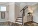 Bright entryway showcases a wooden staircase with white risers and a decorative table at 6282 Tea Olive Dr # Lot 236, Harrisburg, NC 28075