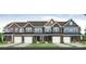 Exterior view of new brick and stone townhomes with attached garages at 6282 Tea Olive Dr # Lot 236, Harrisburg, NC 28075