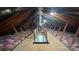 Attic with wooden beams, insulation, and a stairway leading to the lower level at 702 E Grover St, Shelby, NC 28150